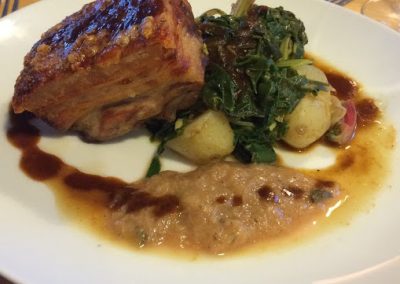 Twice roast pork. With rhubarb and five spice sauce, steamed new potatoes and wilted spring greens.