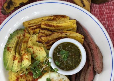 Best of South America plate. Free range eggs, avocado, rice and beans, plantains and steak. With wild garlic chimichurri sauce.
